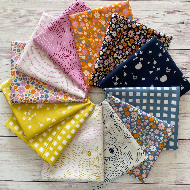 Aneela Hoey marigold fabric fat quarters arranged in a ring
